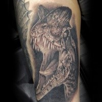 Black ink very detailed forearm tattoo of dinosaur head