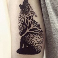 Black ink wolf consisting of wood tattoo on arm