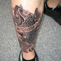 Black koi fish tattoo on leg