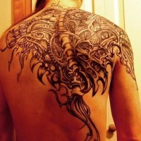 Black mechanical spine tattoo on back