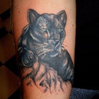 Black panther with green eyes tattoo on leg