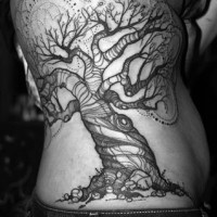 Black patchwork tree tattoo on back