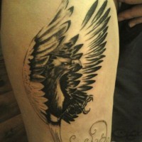Black phoenix tattoo on leg