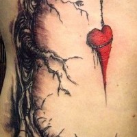Black tree and red hanging on it heart tattoo by Alex Pardee