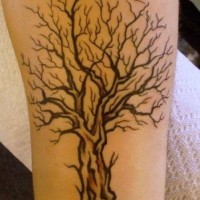 Black tree tattoo on arm