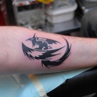 Black tribal phoenix tattoo on arm
