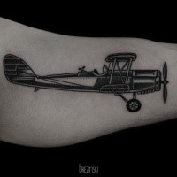 Black work style very detailed biceps tattoo of vintage plane