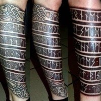 Blackwork style ancient Celtic lettering tattoo on leg