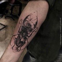 Blackwork style creative forearm tattoo of big black bug stylized with white vortex