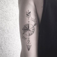 Blackwork style creative looking arm tattoo of compass with arrow