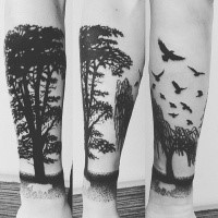 Blackwork style forearm tattoo of trees with flowers