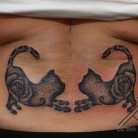 Blackwork style interesting looking waist tattoo of mirrored cats and rose