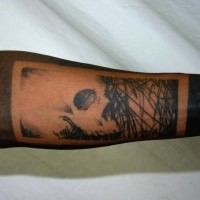 Blackwork style medium size forearm tattoo of jungles