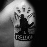 Blackwork style of medium size shoulder tattoo of man with snowboard and lettering