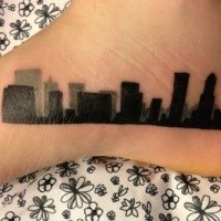 Blackwork style simple small foot tattoo of city sights