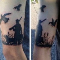 Blackwork style small arm tattoo of hunter with dog and flying ducks