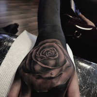 Blackwork style very detailed rose tattoo on sleeve