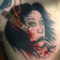 Bloody colored chest tattoo of Asian woman severed head with knife