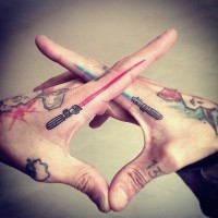 Blue and red light sabers tattoo on both forefingers