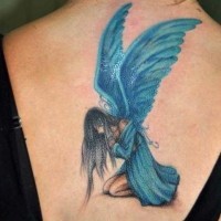 Blue sad fairy tattoo on back