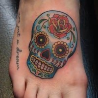 Blue sugar skull with rose foot tattoo