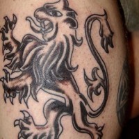 Bohemian black lion tattoo on leg