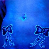 Bows on belly black light tattoo