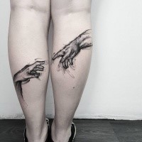 Breathtaking black ink on legs tattoo of human hands