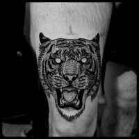 Breathtaking black ink thigh tattoo of tiger mask