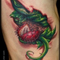 Breathtaking colored side tattoo of under skin predator plant
