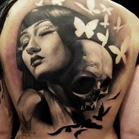 Breathtaking looking black and white upper back tattoo of woman portrait combind with human skull and white butterflies