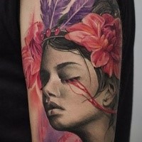 Breathtaking portrait style shoulder tattoo of woman with flowers and feather