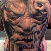 Breathtaking very detailed colored on whole back tattoo of monster witch face