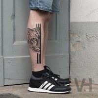 Brilliant designed by Valentin Hirsch black ink leg tattoo of split leopard head with black lines