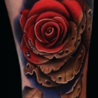 Brilliant detailed and colored little rose tattoo on ankle