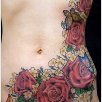 Brilliant painted massive multicolored floral tattoo with butterfly on waist