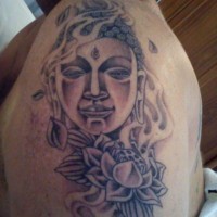 Buddhist face tattoo on half sleeve