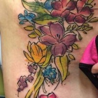 Carelessly painted big colored floral tattoo