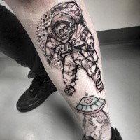 Carelessly painted by Inez Janiak leg tattoo of astronaut skeleton
