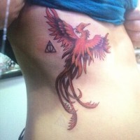 Cartoon like big colored mystical on side tattoo of phoenix bird