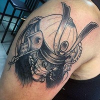 Cartoon like black and white detailed shoulder tattoo of samurai mask