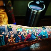 Cartoon like colored and designed Lord's Supper picture tattoo on sleeve