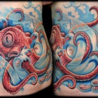 Cartoon like colored big octopus in waves tattoo on belly