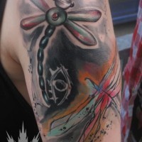 Cartoon like colored flying dragonfly tattoo on shoulder combined with abstract painted dragonfly