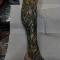 Cartoon like colored jellyfish with old divers helmet tattoo on leg