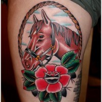 Tatuaje en el muslo,  caballo pardo en el marco decorado con flor