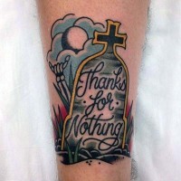 Cartoon like colored tombstone with lettering tattoo on leg