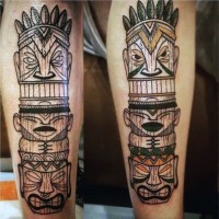 Cartoon like colored tribal statue tattoo on leg
