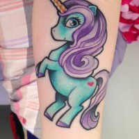 Cartoon like little colored forearm tattoo of baby unicorn