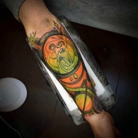 Cartoon like multicolored space monster monkey tattoo on arm